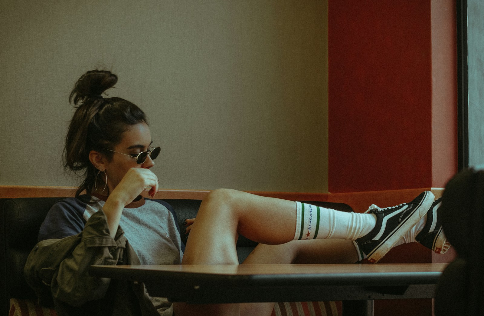 Photo by Allef Vinicius woman sitting on couch