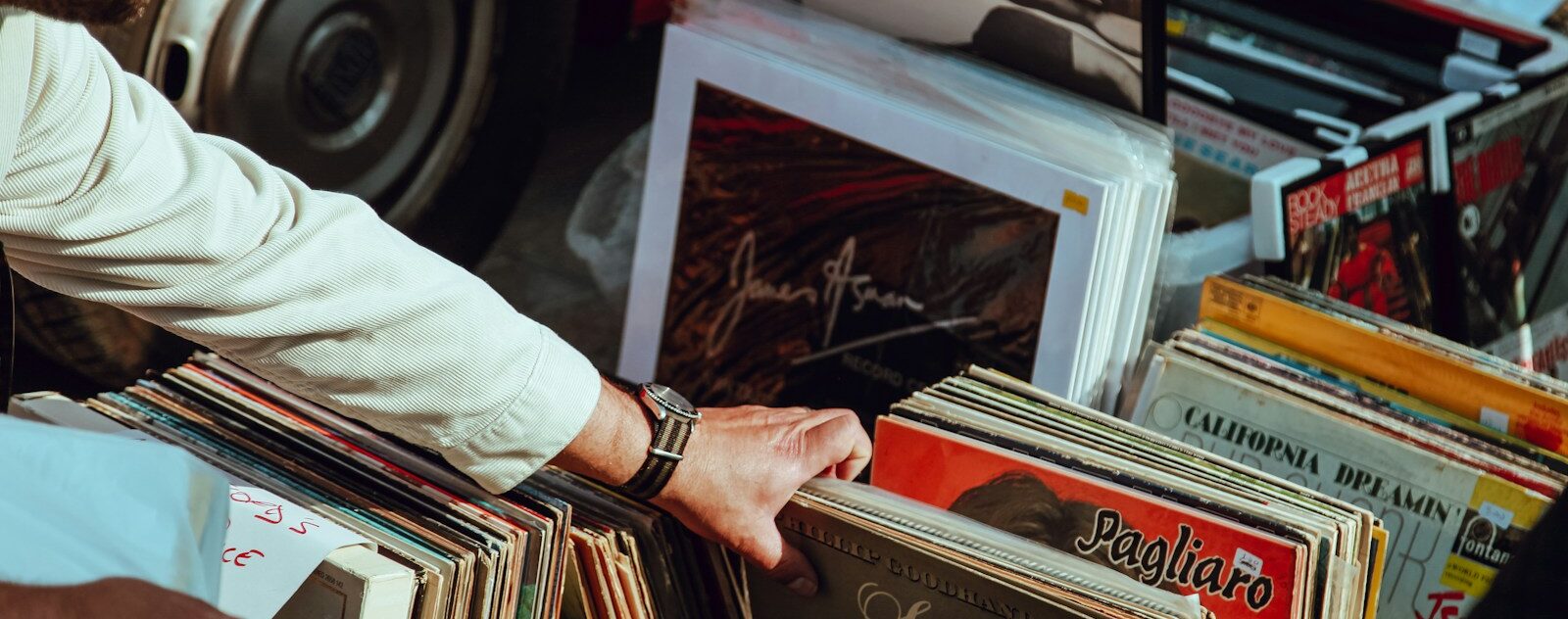 Photo by Clem Onojeghuo person holding vinyl records